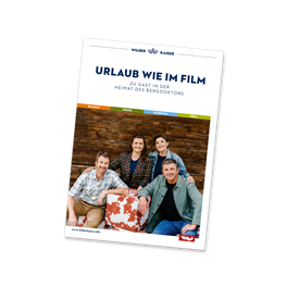 Ein Buchcover mit dem Titel "Urlaub wie im Film". Darauf sind vier Personen abgebildet, die lächeln und entspannt posieren.