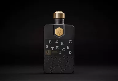 A stylish bottle with black packaging and a golden cap. The text "BERGSTEIGER" is clearly visible and gives the bottle a modern look.