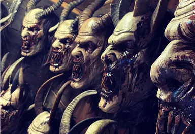 A series of creepy masks with horns and distorted faces. The masks look dark and terrifying.