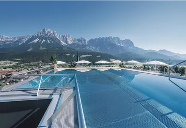 A stunning infinity pool overlooking majestic mountains. The surroundings are calm and inviting, perfect for relaxation.