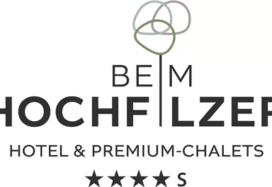 A stylish logo for the hotel and premium chalets "Beim Hochflzer". It features elegant lettering and a modern design.