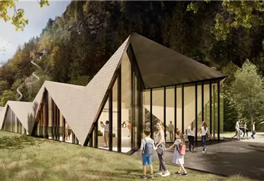 Ein modernes Gebäude mit einer einzigartigen architektonischen Form in einer natürlichen Umgebung. Familien genießen die Zeit im Freien vor dem Gebäude.