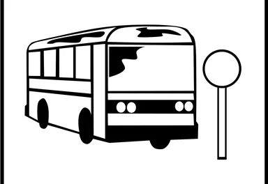 A bus is at a stop. Next to the bus is a stop sign.