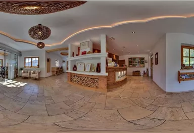 A modern and bright foyer with elegant design. There is a reception desk and plenty of space for guests.