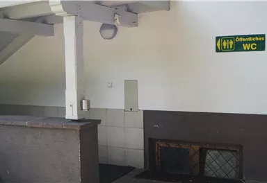 Access to public washrooms is visible.
Next to the entrance, there is a sign with directions.