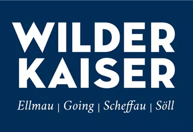 A logo with the text "Wilder Kaiser" in large, white font on a dark blue background. The places Ellmau, Going, Scheffau, and Söll are listed below.