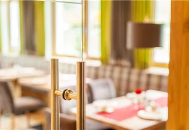 A modern restaurant with an inviting atmosphere. The view shows elegant furniture and a bright, friendly space.