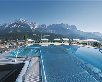 A stunning infinity pool overlooking majestic mountains. The surroundings are calm and inviting, perfect for relaxation.