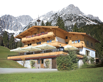 A charming wooden house surrounded by green meadows and majestic mountains. Snow-capped peaks are visible in the background.