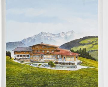 A large, picturesque wooden house in a green hill and mountain landscape. The scene shows clear skies and surrounding forests.