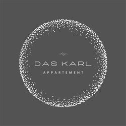 A stylish logo for "Das Karl Appartement". It features the lettering in an elegant design on a gray background.