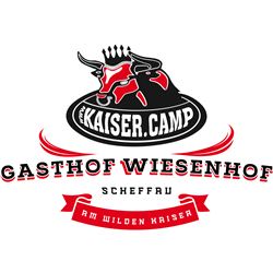 A logo of the Wiesenhof inn featuring a cow and various inscriptions. The design is colorful and inviting.