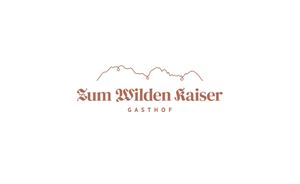 Ein einfaches Logo mit dem Schriftzug „Zum Wilden Kaiser“ und der Bezeichnung „Gasthof“. Im Hintergrund sind stilisierte Bergkonturen zu sehen.