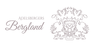 An elegant logo featuring the inscription "Adelsbergers Bergland" along with a detailed coat of arms. The design is simple and has a classic character.