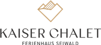 An elegant logo for the Kaiser Chalet holiday home Seiwald. It features a stylized mountain landscape in golden and black colors.