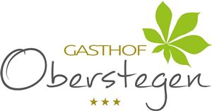 A stylish logo of the Gasthaus Oberstegen. It features the name in elegant lettering with a green leaf.