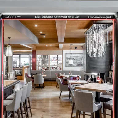 An elegant restaurant with stylish interior and a cozy atmosphere. The lighting and decoration create an inviting mood.
