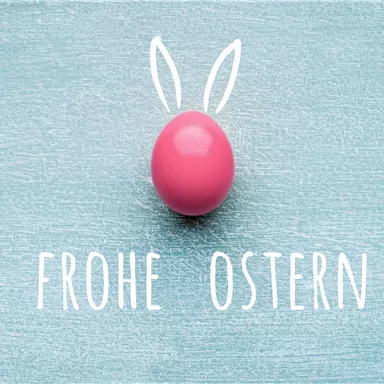 A pink Easter egg with a donkey ear design on a blue surface. Below it is the text "Happy Easter".