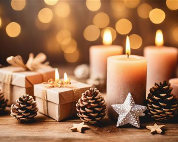 A festive decoration with candles, gifts, and pine cones. Soft lights sparkle in the background.