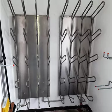 Two metal coat racks with multiple hooks are mounted on the wall. The space looks clean and functional.