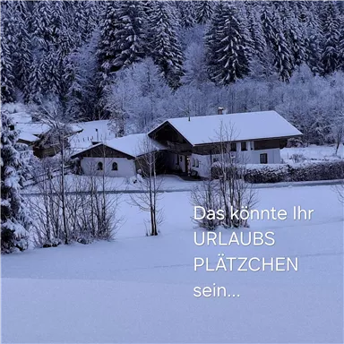 A snow-covered holiday home surrounded by snow-covered trees. The tranquil winter landscape invites relaxation.