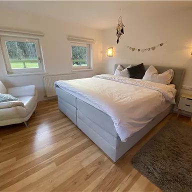 Ein modernes Schlafzimmer mit einem großen, bequemen Boxspringbett.