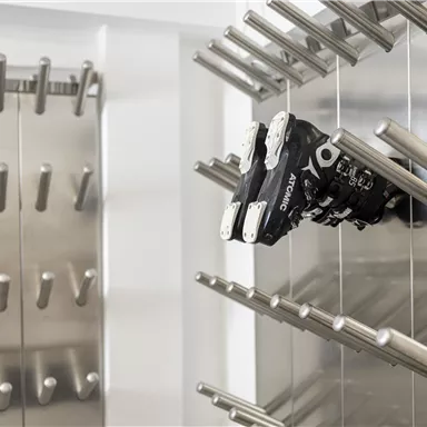 A modern robotic unit is mounted on a frame with metallic rods. The environment appears clean and futuristic.