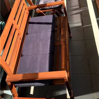 A balcony with two wooden seats. The furniture is comfortable and offers space to relax.