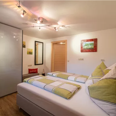 A cozy bedroom with two beds and a modern design.
Soft lighting and harmonious colors create an inviting atmosphere.