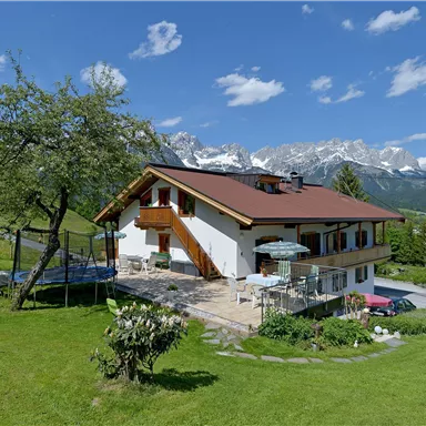 A beautiful house in a quiet landscape with a magnificent view of the mountains. The garden is green and includes a playground.