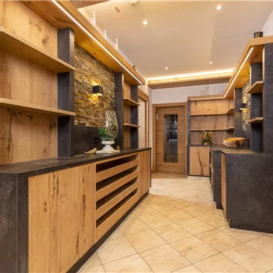 A modern interior with wooden shelves and dark accents. The room has an inviting atmosphere with warm lighting.