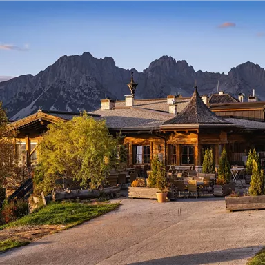 A cozy wooden building with mountain views. Surrounded by trees and a picturesque landscape.