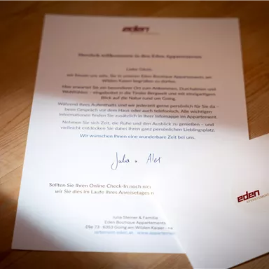 A letter and an envelope, both featuring the logo "eden". The text is friendly and informal, addressed to a person.