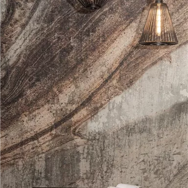 A modern room with a textured wall and two stylish lamps. A black table with a magazine complements the ambiance.