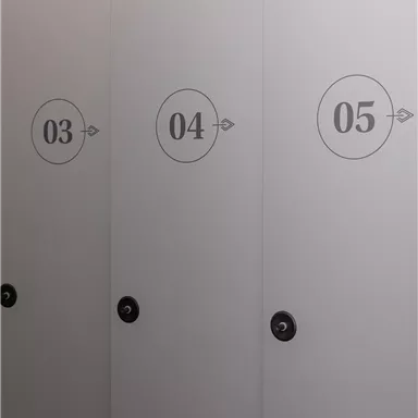 Three gray cabinet doors with the numbers 03, 04, and 05 are visible. The doors are designed in a simple and modern style.