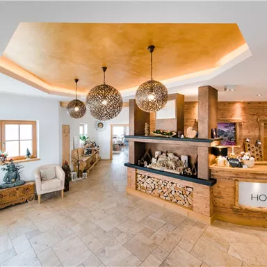A modern reception with warm wooden elements and stylish pendant lights. The space is bright and inviting, perfect for a pleasant welcome.