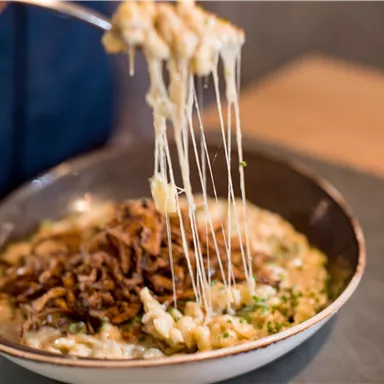 A delicious dish with melting cheese and crispy onions. The rich sauce is perfect for any gourmet.