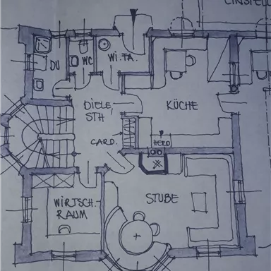 A floor plan of a house with various rooms, such as a kitchen, living room, and utility room. The drawing also shows a staircase and the entrance area.