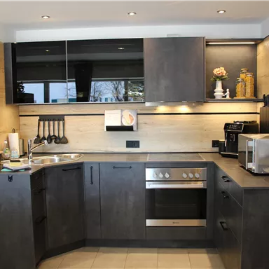 The kitchen is very well equipped with appliances and has a bright, inviting space.