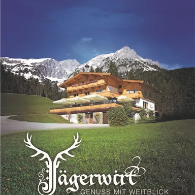 A picturesque chalet amidst green meadows and majestic mountains. The bright blue sky gives the scene an inviting atmosphere.
