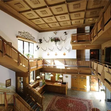 An inviting reception area with wood paneling and decorative hunting trophies.  
Large windows let in plenty of light and create a friendly atmosphere.