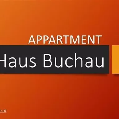 A modern apartment with the inscription "Haus Buchau" in Ellmau. The background color is orange, and the contact details are visible.