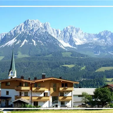 A picturesque mountain village with a church and charming wooden houses. In the background, majestic mountains rise under a clear blue sky.