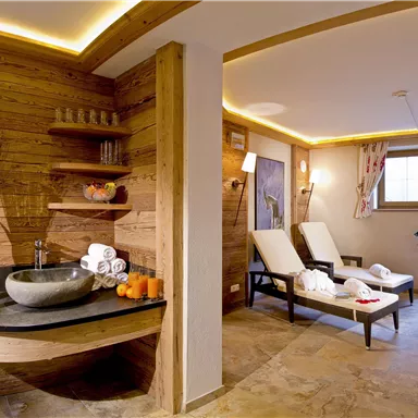 A stylish spa with warm wood details and modern loungers. The room is bright and inviting, ideal for relaxation and wellness.