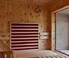 A cozy sauna with wooden walls and benches. The atmosphere is calm and relaxing.