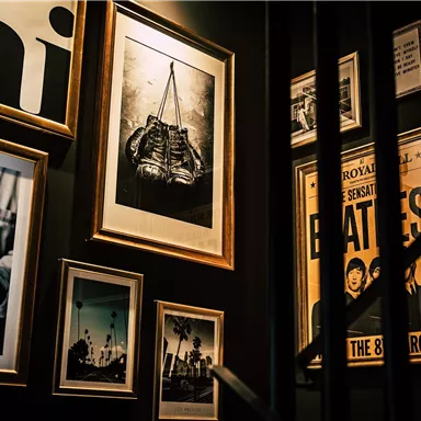 A wall with several framed pictures and photographs. The images depict a nostalgic atmosphere with different motifs.