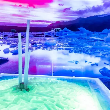 A colorful landscape with icebergs and calm water. The sky glows in purple and pink hues.