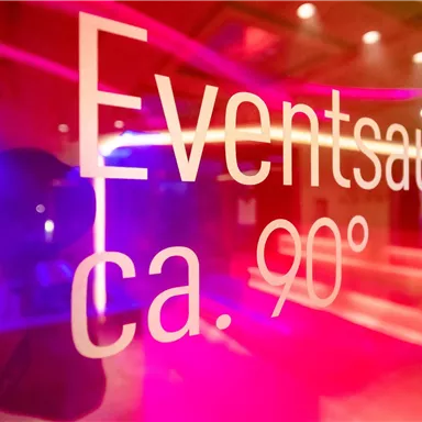 A modern event sauna with colored lighting. The temperature is approximately 90 degrees.