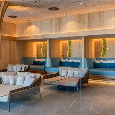 A modern and elegant lounge interior with wooden paneling and cozy sofas. Soft lighting creates a relaxing atmosphere.