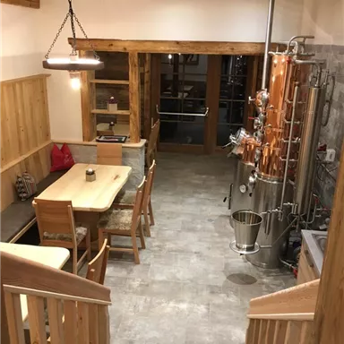 Eine gut eingerichtete Brennerei mit Holzdetails und modernen Geräten. Der Raum ist hell und freundlich, ideal für die Herstellung von Spirituosen.
